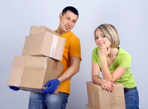Professional movers carrying boxes during a Hendon relocation